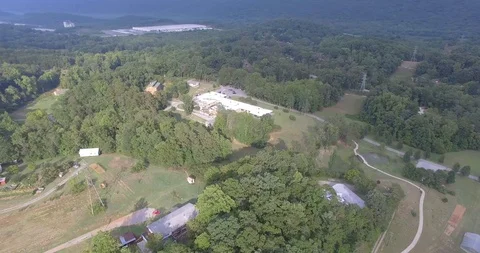 Drone Flying Over Small Valley Town Between Mountains, Flat Footage Stock Footage 107321363