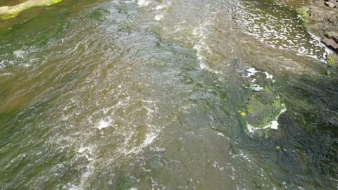 Drone flying over a small waterfall Video stock 246717650