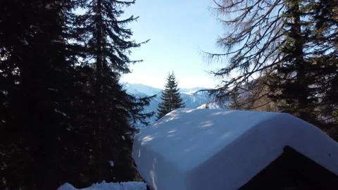 Drone flying over snow covered wooden cabin in the mountains Stock Footage 145800529