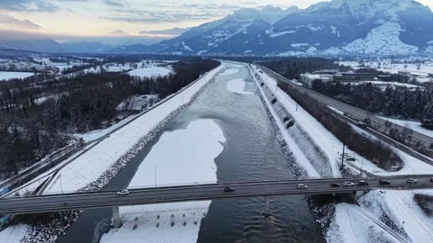 Drone flying over a snow-covered sandbank and bridge 스톡 동영상 329557782