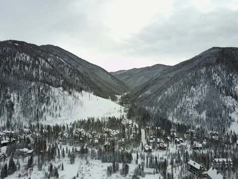 Drone flying over snow town 4K Stock Footage 71360424