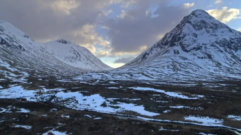 Drone flying over snowy Glencoe mountains in Scotland Stock Footage 336796390