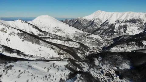 Drone Flying Over Snowy Mountains and Village in Cuneo Italy Winter Landscape Vidéo 331661815