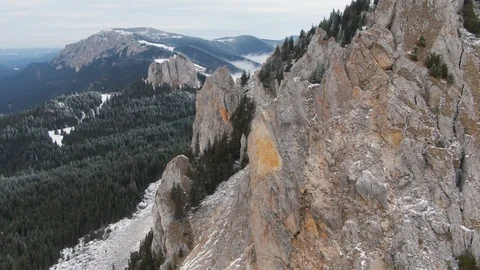 Drone flying over snowy pine forest reaching a nab, cliff Video stock 126904067