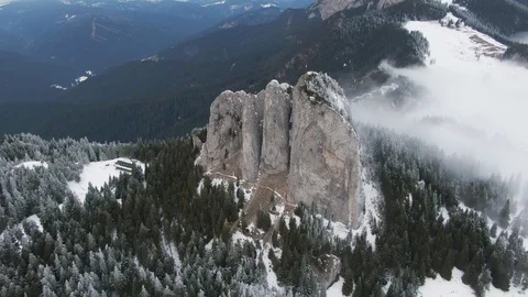 Drone flying over snowy pine forest reaching a nab, cliff Stock Footage 126904098