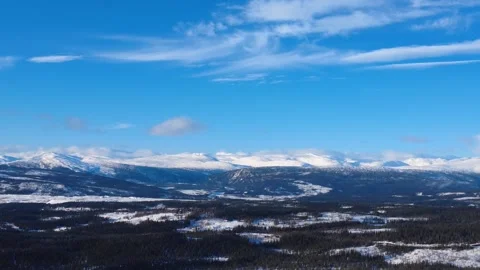Drone flying over snowy pine forest canopy in Norway winter 4K Video stock 328990797