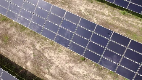 Drone flying over a solar panel farm producing renewable energy Video stock 343831651