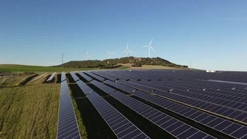 Drone Flying Over Solar Panels with Wind Turbines on Hill Stock Footage 331200702