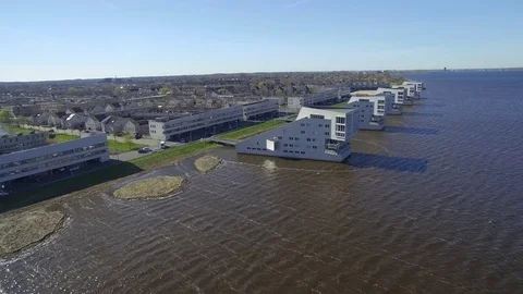 Drone flying over sphinx homes in Huizen Noord-Holland Stock Footage 75351823