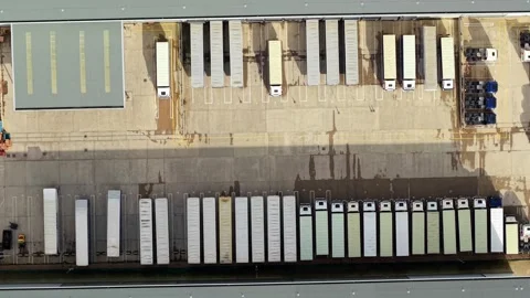 Drone flying over sprawling industrial estate and logistics warehouses with Vídeos de archivo 340268456