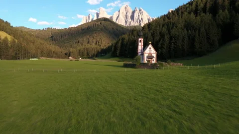 Drone flying over St Valentin Church in Dolomites, Italian Alps. Mountains in th Stock Footage 167060405