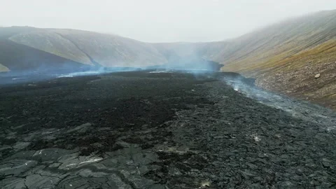 Drone flying over steaming hot lands near Geldingadalir active Volcano Stock Footage 233035747