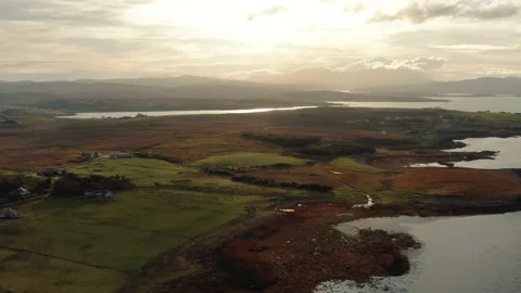 Drone flying over still calm reflective lake during sunrise in Isle of Skye Stock Footage 167732750