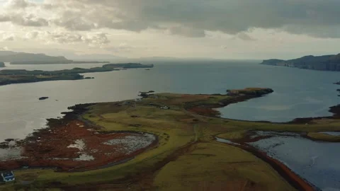 Drone flying over still calm reflective lake during sunrise in Isle of Skye Stock Footage 167733022