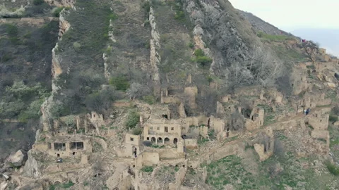 Drone flying over stone ruins of abandoned ancient ghost town Gamsutl, Dagestan Stock Footage 196165052