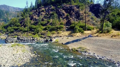 Drone Flying Over Stream of Water and Camping River 4k Stock Footage 81249357