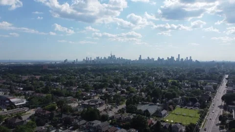 Drone flying over suburbs towards downtown toronto skyline on cloudy day Stock Footage 252007295
