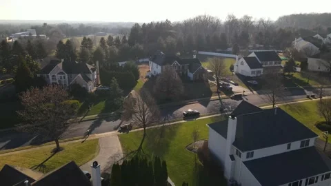 Drone flying over a sunny quiet suburban neighborhood Stock Footage 228698974