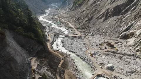 Drone flying over temporary bridges along the dusty paths surrounding teesta Stock Footage 311389036