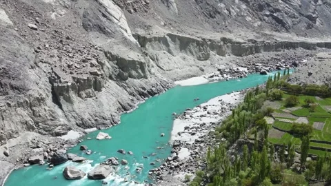 Drone Flying over Terraced fields and towards green glacial water river Stock Footage 240136914