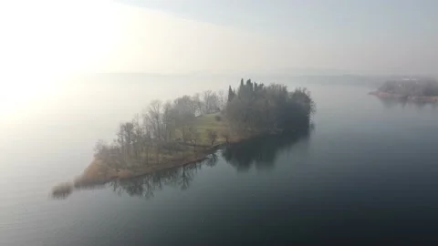 Drone Flying Over A tiny quiet island over the Lake in a winter cold day Stock Footage 170159389