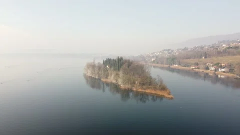 Drone Flying Over A tiny quiet island over the Lake in a winter cold day Stock Footage 170159409