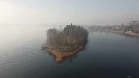 Drone Flying Over A tiny quiet island over the Lake in a winter cold day Stock Footage 170159414