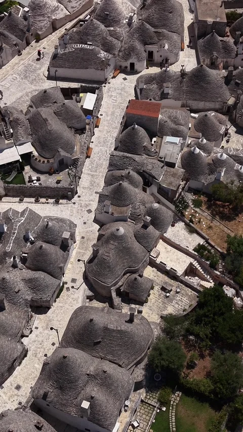 Drone flying over the traditional conical roofs of trulli Stock Footage 340149559