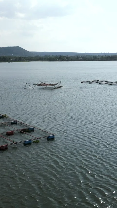 Drone flying over tri an lake vietnam over the fish farms on a day of wind and Stock Footage 279900546
