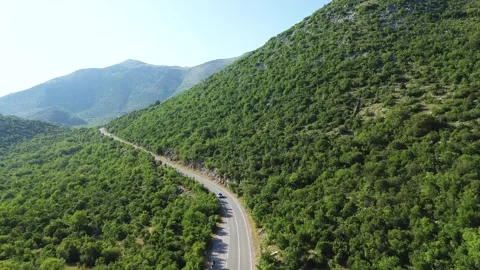 Drone Flying Over Trnova Mountains and Forest with Road Traffic – 4K Aerial Stock Footage 313900410