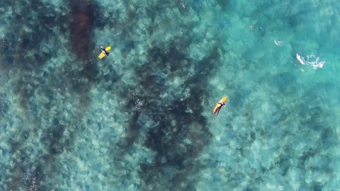 Drone flying over turquoise water with surfers with INSPIRE 2 drone Stock Footage 101428262