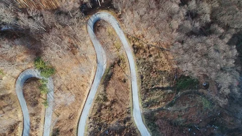 Drone flying over a twisty mountain road Stock Footage 101419822