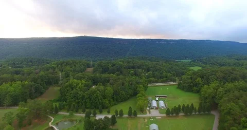 Drone Flying Over Valley Surrounded By Mountains Stock Footage 107321362