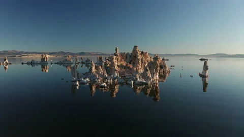 Drone flying over vertical sharp tufa formations raising above blue lake, 4K 스톡 동영상 144650728