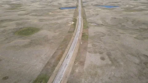 Drone flying over a very dry and barren looking prairie cattle country landscape Stock Footage 255046148
