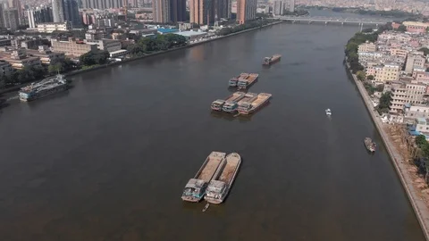 A drone flying over a very polluted navigable river in the city. Stock Footage 118212424
