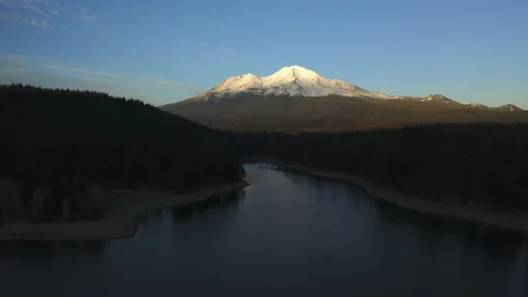 Drone flying over water looking over Mt. Shasta in the Oregon forest Stock Footage 145859012
