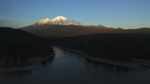 Drone flying over water looking over Mt. Shasta in the Oregon forest Stock Footage 145859121