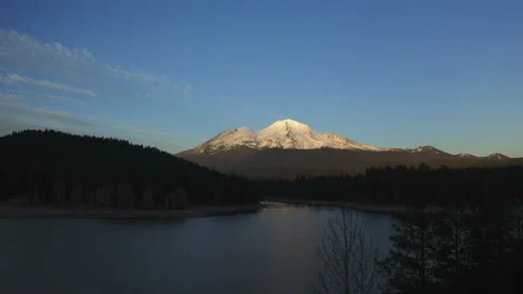 Drone flying over water looking over Mt. Shasta in the Oregon forest Stock Footage 145859134