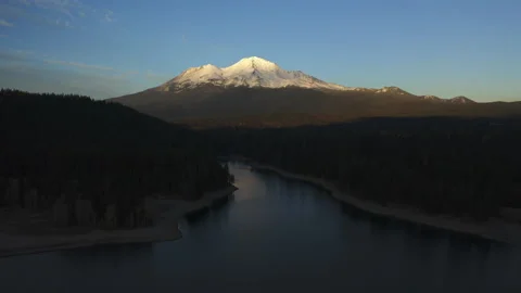 Drone flying over water looking over Mt. Shasta in the Oregon forest Stock Footage 145859149