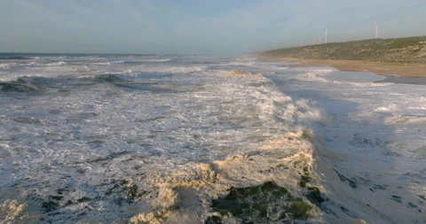 Drone flying over the white foam and waves near the sandy sea coastline. Tide Stock Footage 223425418