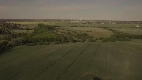Drone Flying Over Wind Turbines Near Rural Village and Road Stock Footage 243138227