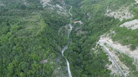 Drone flying over a winding mountain road Stock Footage 248361118