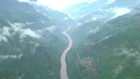 Drone flying over a winding river nestled in the heart of the mountains. Stock Footage 310883064