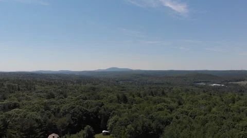 Drone Flying Over Woods with Mountain in the Distance Vídeo Stock 92178561