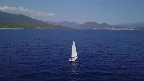 Drone flying over a yacht on blue sea in 4K Stock Footage