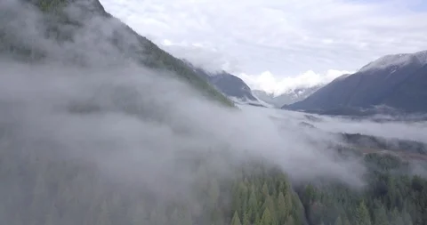 Drone Flying Past Cloudy Mountain Stock Footage 100088204