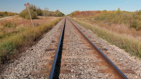 Drone flying rapidly and low along a railway line with fall colors. Stock Footage 116752415