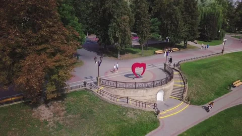 Drone flying right above heart statue in park in Grodno, Belarus Stock Footage