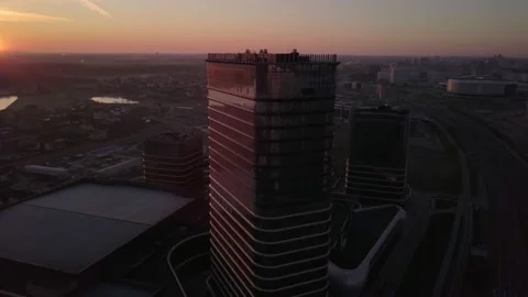 Drone flying right up around city tower in epic early red sunrise Minsk,Belarus Stock Footage